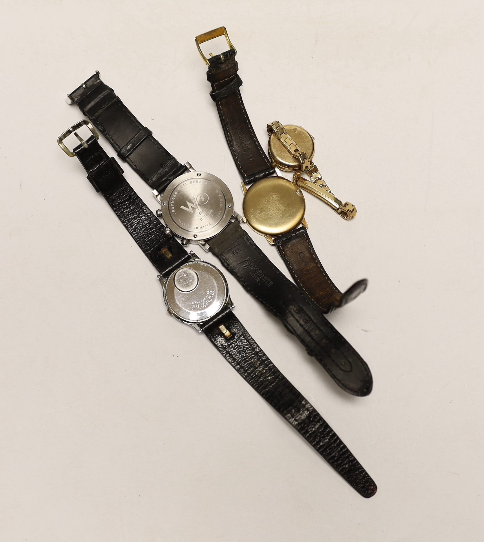 Three assorted gentleman's wrist watches including Raymond Weil, Timex and a 9ct gold quartz wrist watch, retailed by Garrard, together with a lady 9ct gold manual wind wrist watch, on steel and gold plated bracelet.